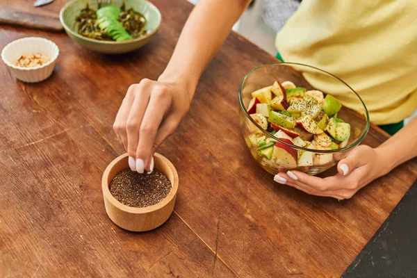 stock-photo-cropped-view-woman-taking-sesame-seeds-wooden-bowl-fresh-fruit