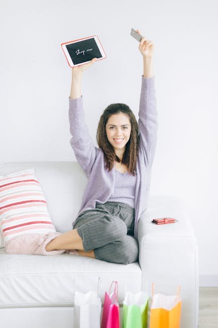 Smiling young woman sitting indoors enjoying a fresh slice of watermelon.